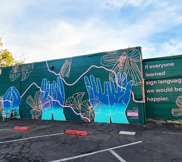 "Sign Language Mural," by Valerie Rose (@hellovalerierose) (W. 1st between Wall and Main)